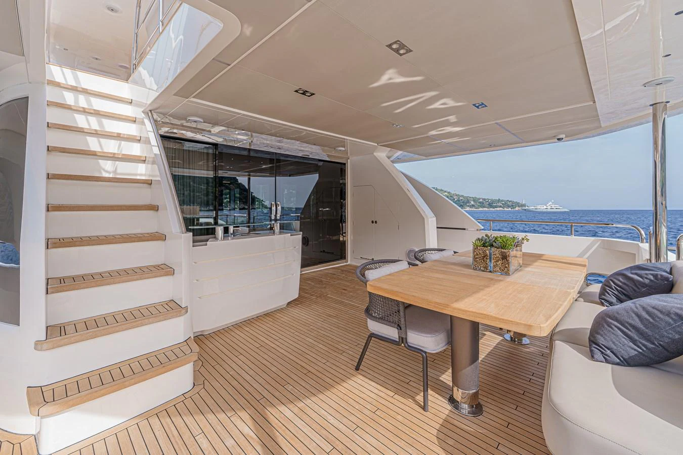 a room with a table and a couch aboard AVALON Yacht for Sale