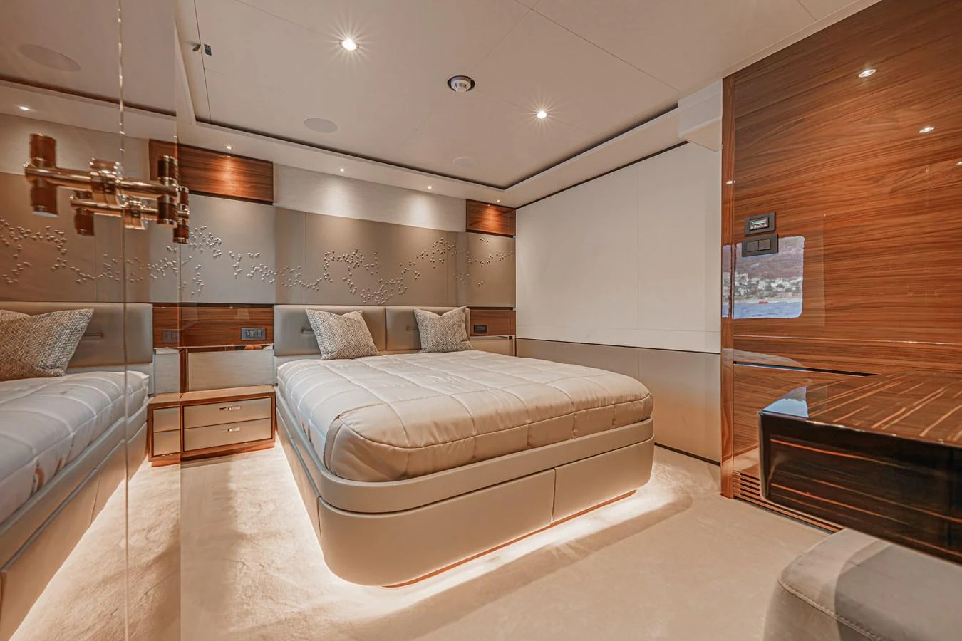 a bedroom with a bed and a fireplace aboard AVALON Yacht for Sale