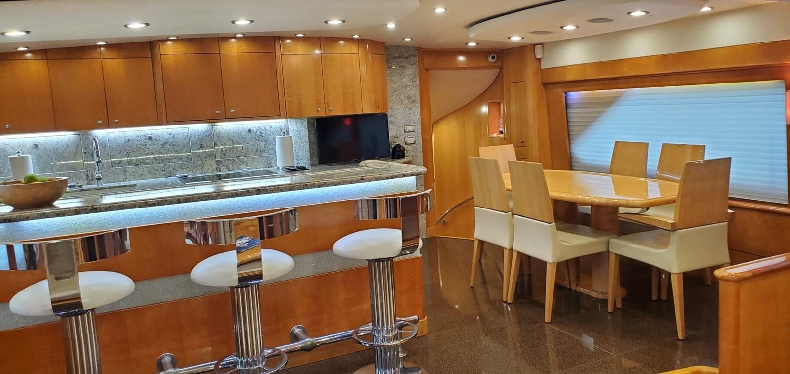 a kitchen with a table and chairs aboard RUMBERA Yacht for Sale