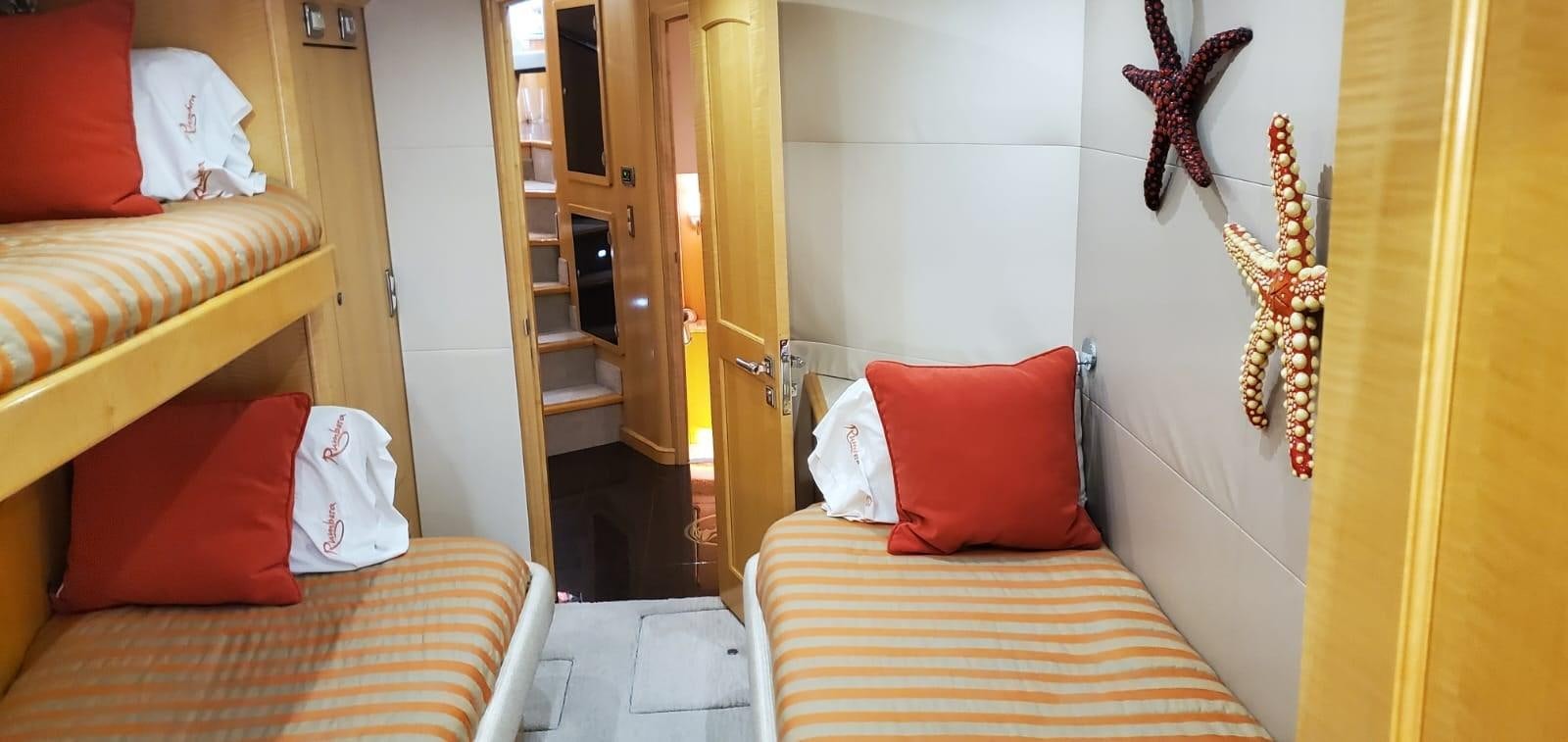 a room with a bed and a door aboard RUMBERA Yacht for Sale