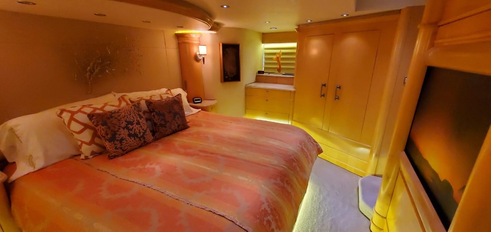 a bedroom with a bed and a closet aboard RUMBERA Yacht for Sale