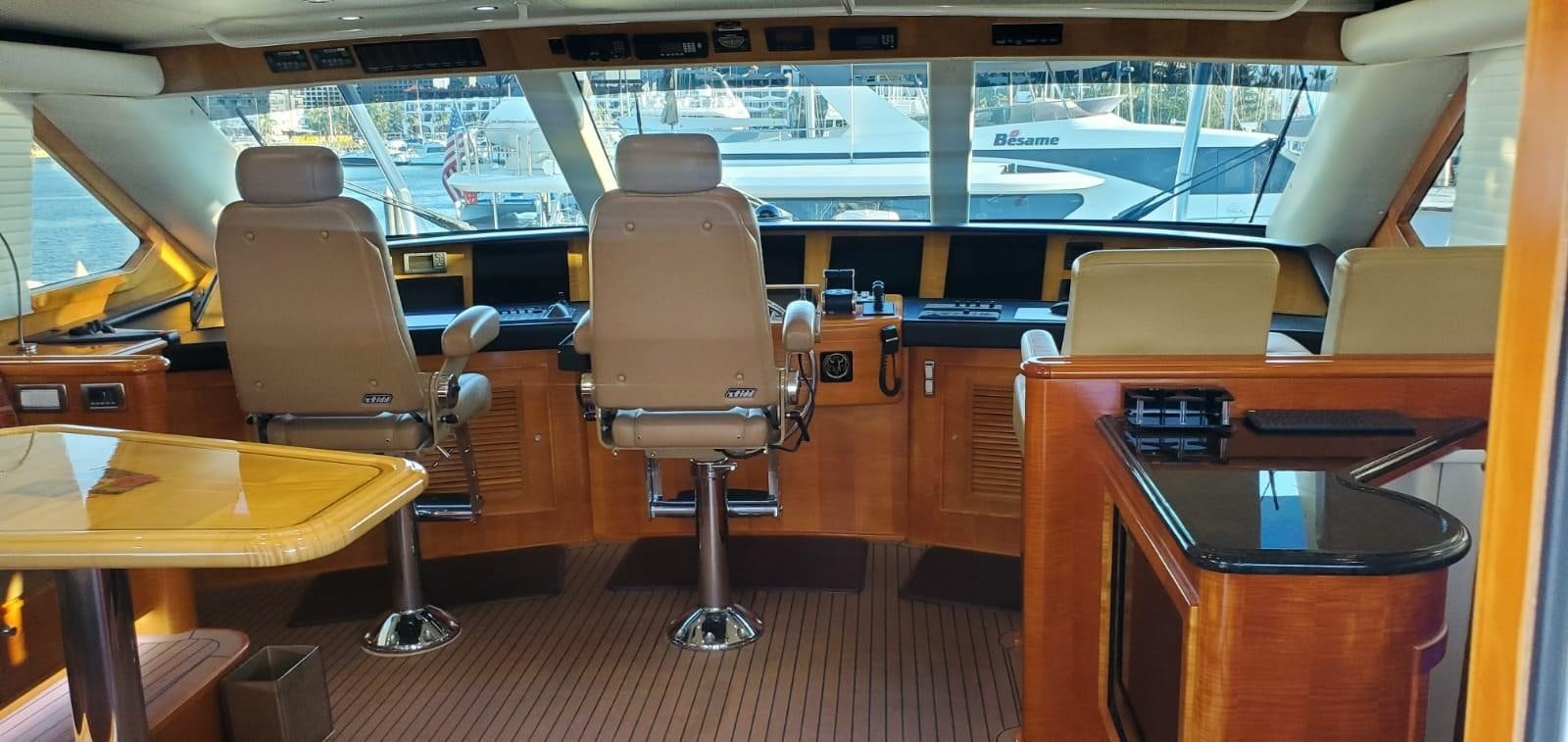 a room with a table and chairs aboard RUMBERA Yacht for Sale