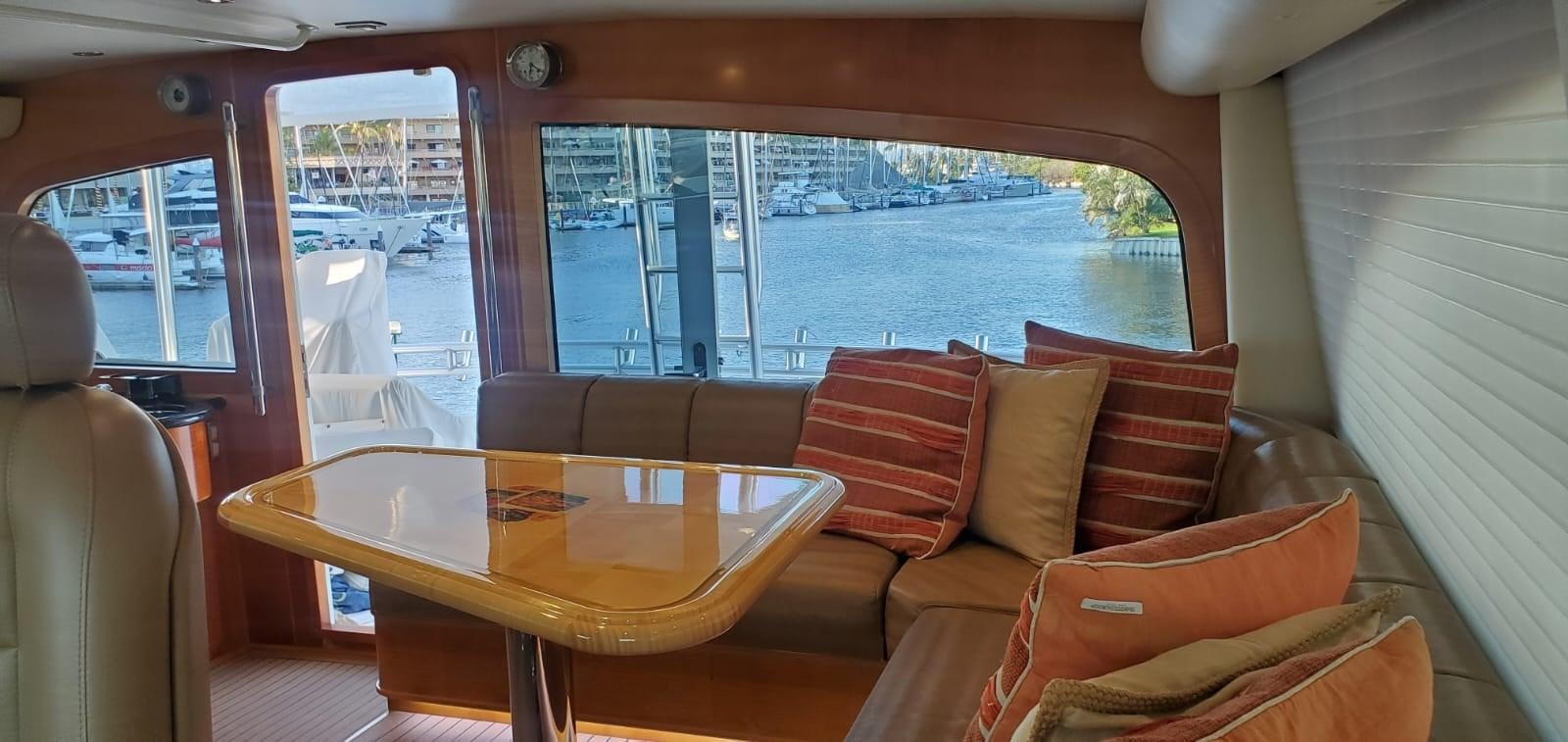 a living room with a table and chairs aboard RUMBERA Yacht for Sale