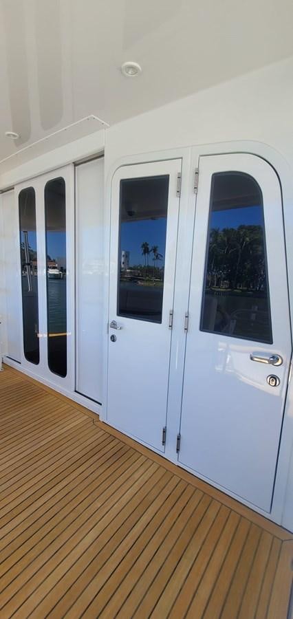 a white door with glass doors aboard RUMBERA Yacht for Sale