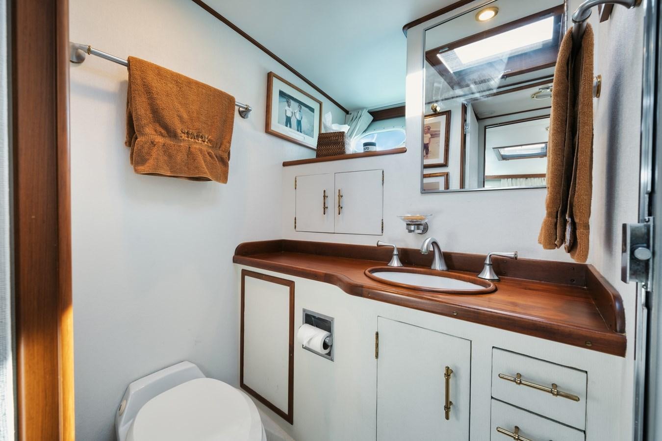 a bathroom with a sink and towels aboard SHARK Yacht for Sale