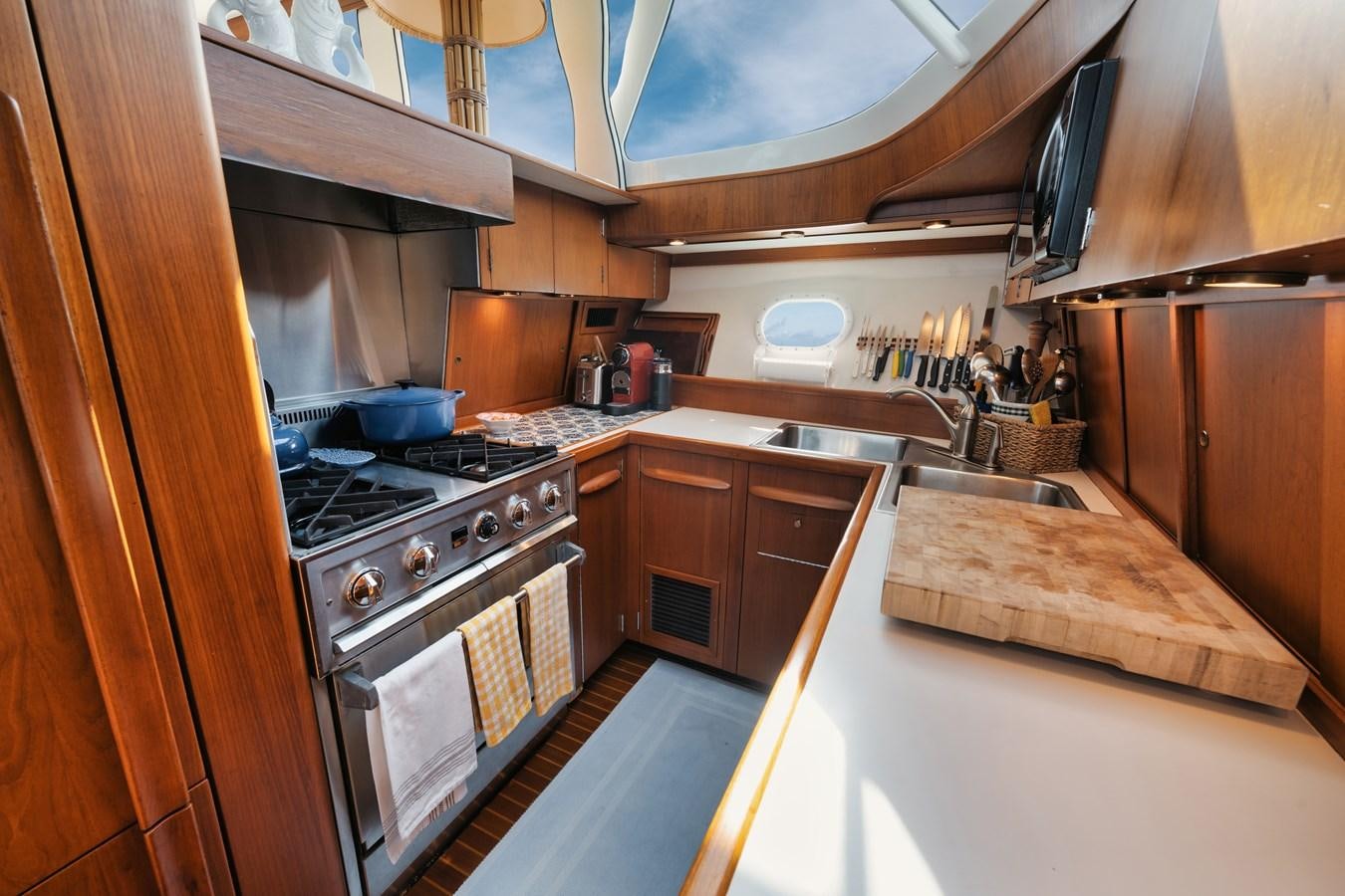 a kitchen with wooden cabinets aboard SHARK Yacht for Sale