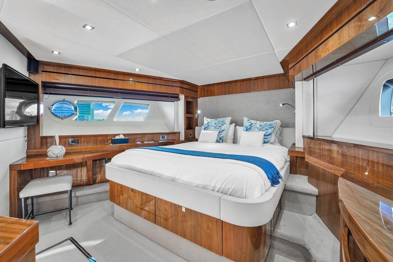 a room with a bed and a desk aboard 92' SUNSEEKER 2016 Yacht for Sale