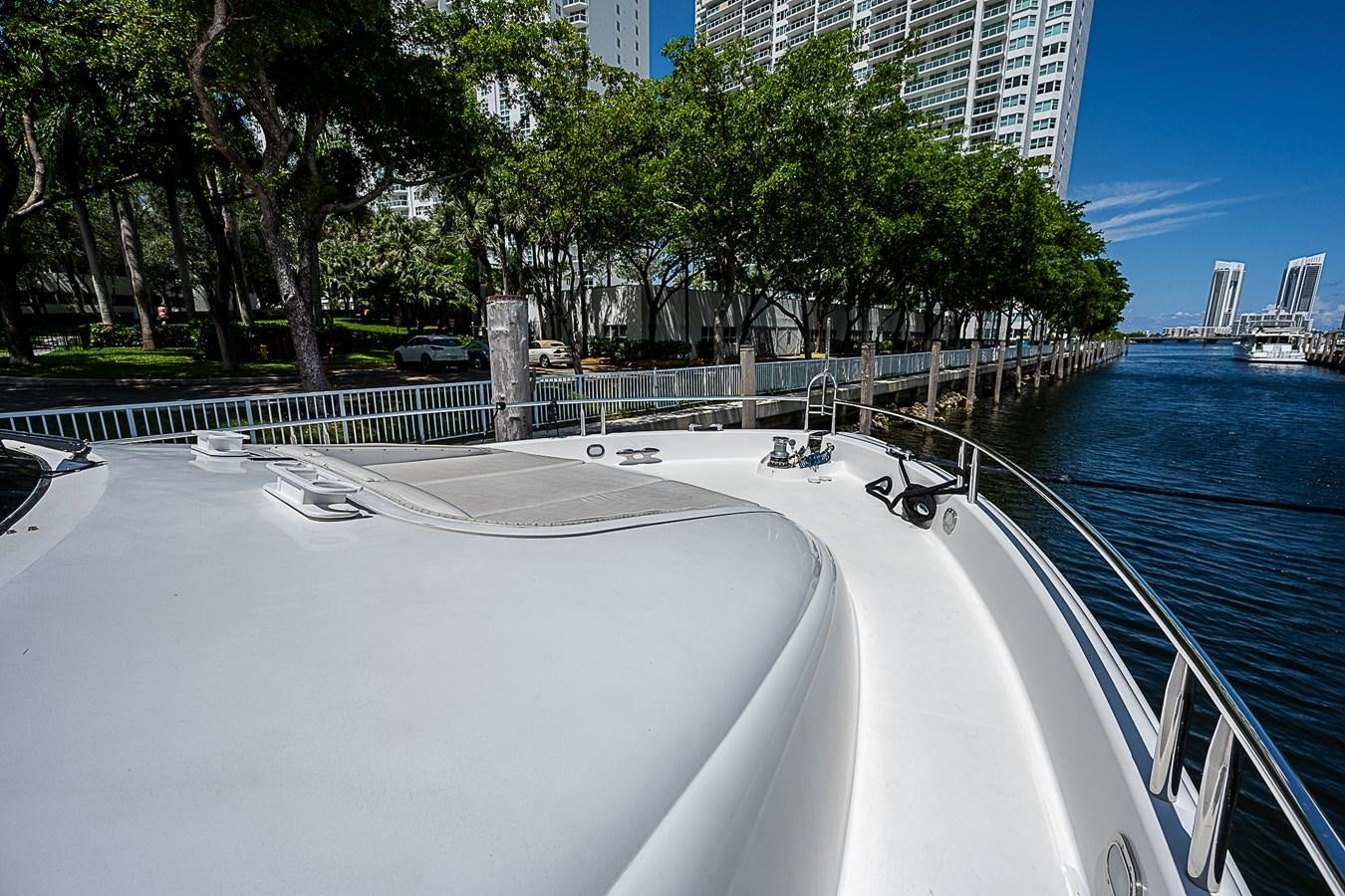 a large pool with a walkway and trees around it aboard FINALLY Yacht for Sale