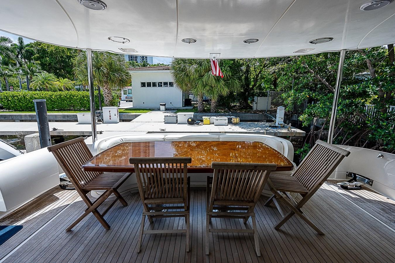 a table and chairs on a patio aboard FINALLY Yacht for Sale