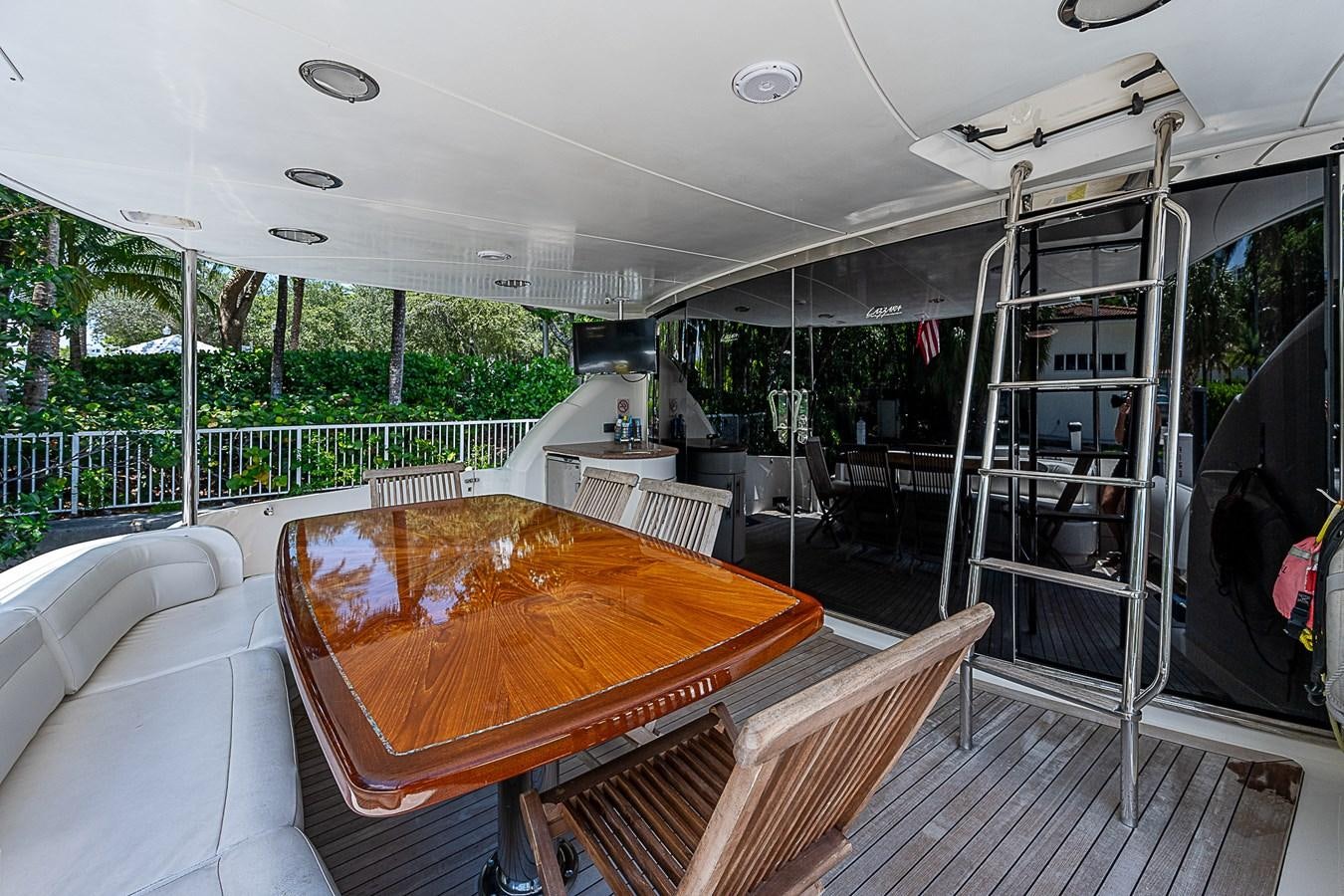 a large room with a table and chairs aboard FINALLY Yacht for Sale