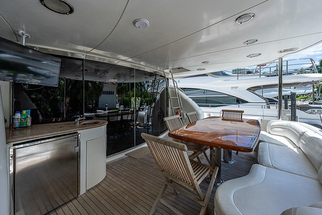 a boat with a table and chairs aboard FINALLY Yacht for Sale
