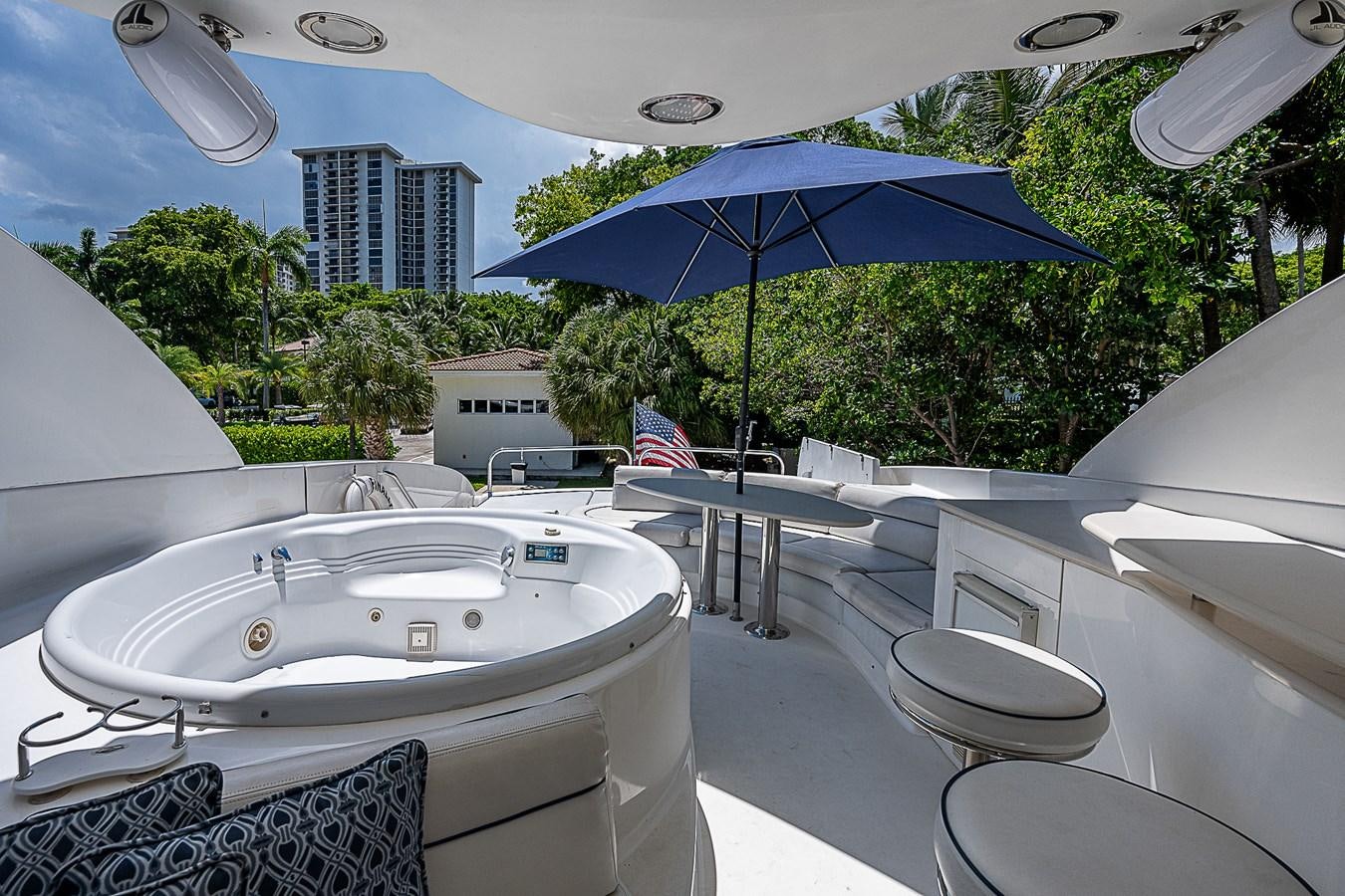 a large white bathtub with a blue umbrella and a blue umbrella aboard FINALLY Yacht for Sale