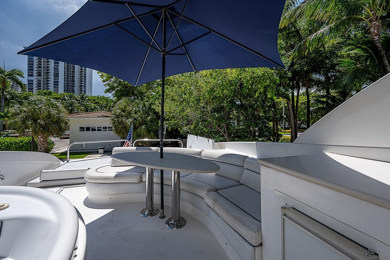 a table and umbrella on a patio aboard FINALLY Yacht for Sale