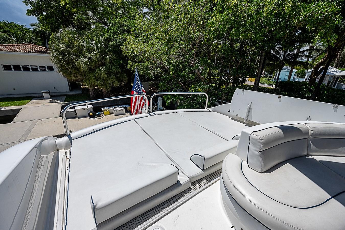 a boat with a flag on the front aboard FINALLY Yacht for Sale