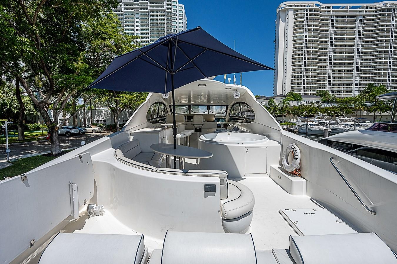 a boat with an umbrella aboard FINALLY Yacht for Sale