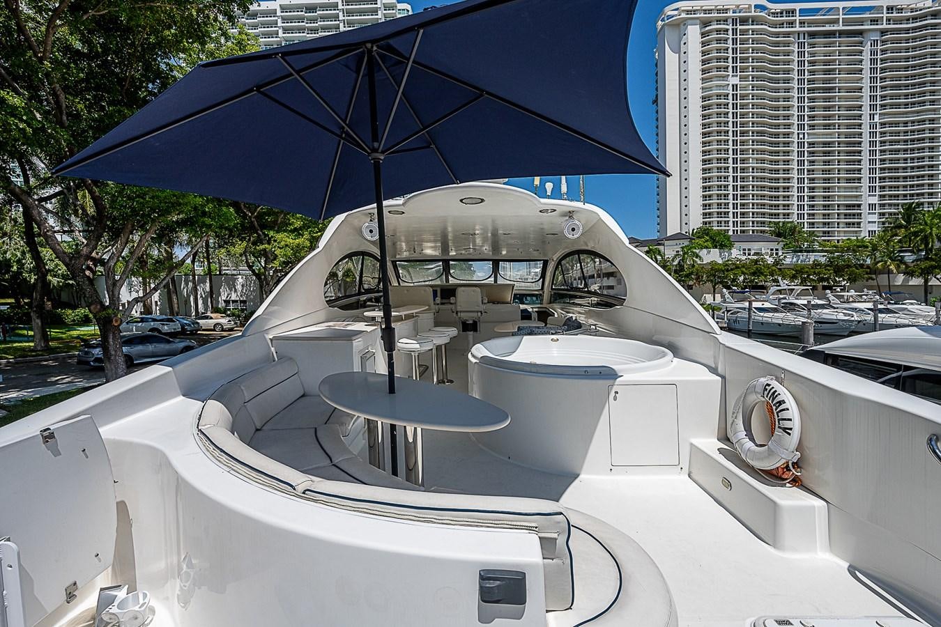 a white car with a blue umbrella aboard FINALLY Yacht for Sale