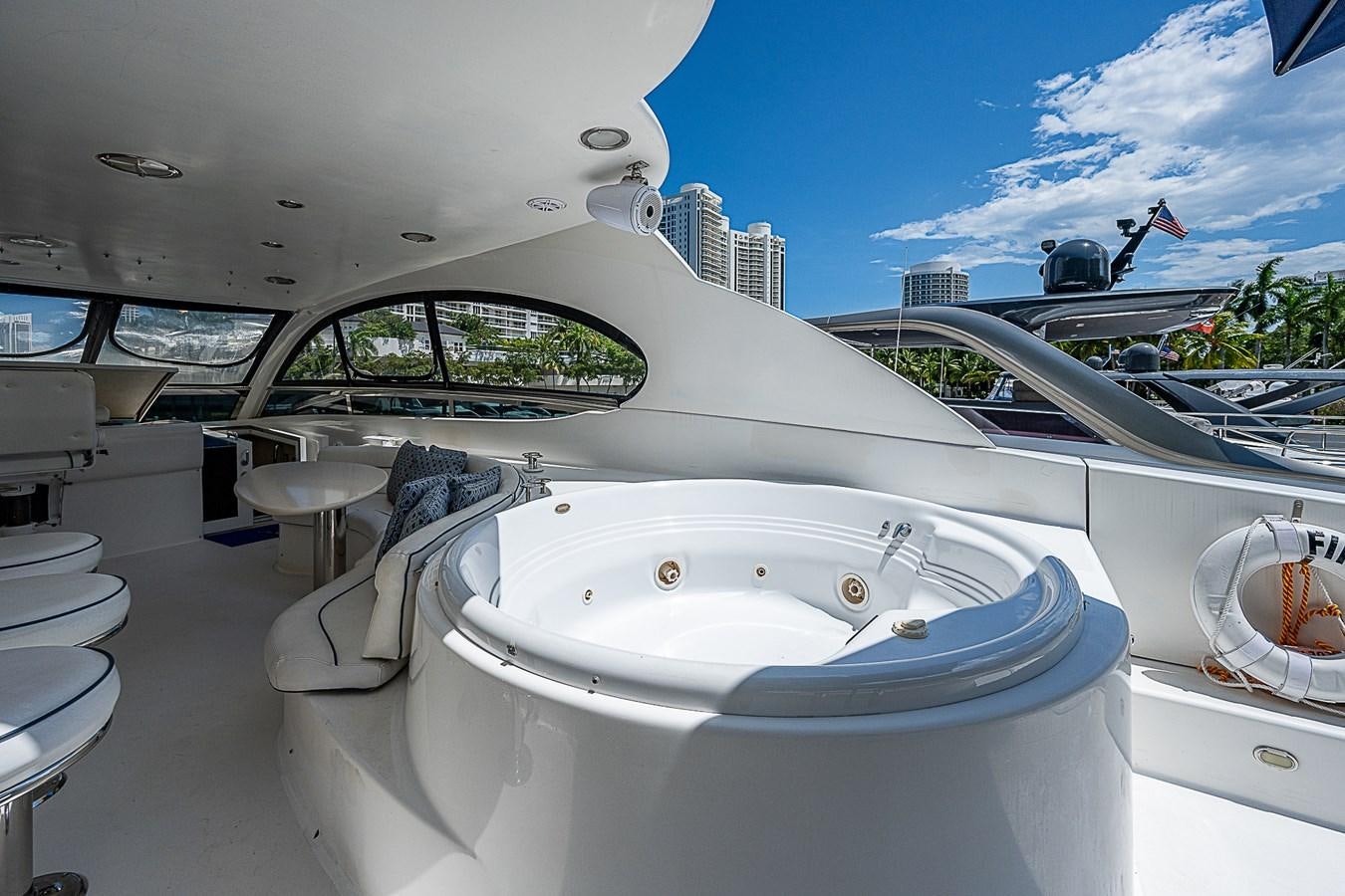 a white boat with a large round window and a white boat in the water aboard FINALLY Yacht for Sale