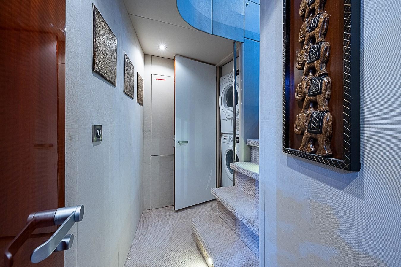 a hallway with paintings on the wall aboard FINALLY Yacht for Sale