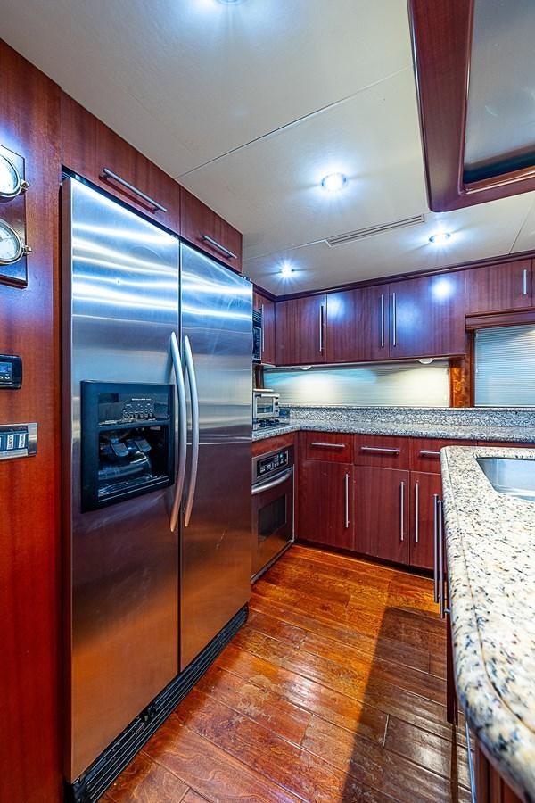 a kitchen with a stainless steel refrigerator aboard FINALLY Yacht for Sale