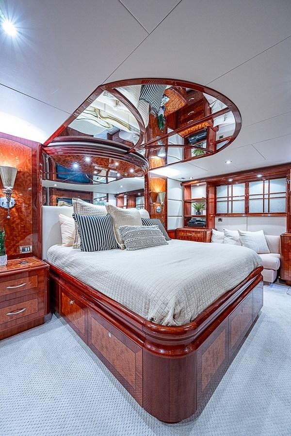 a bed with a round mirror above it aboard FINALLY Yacht for Sale