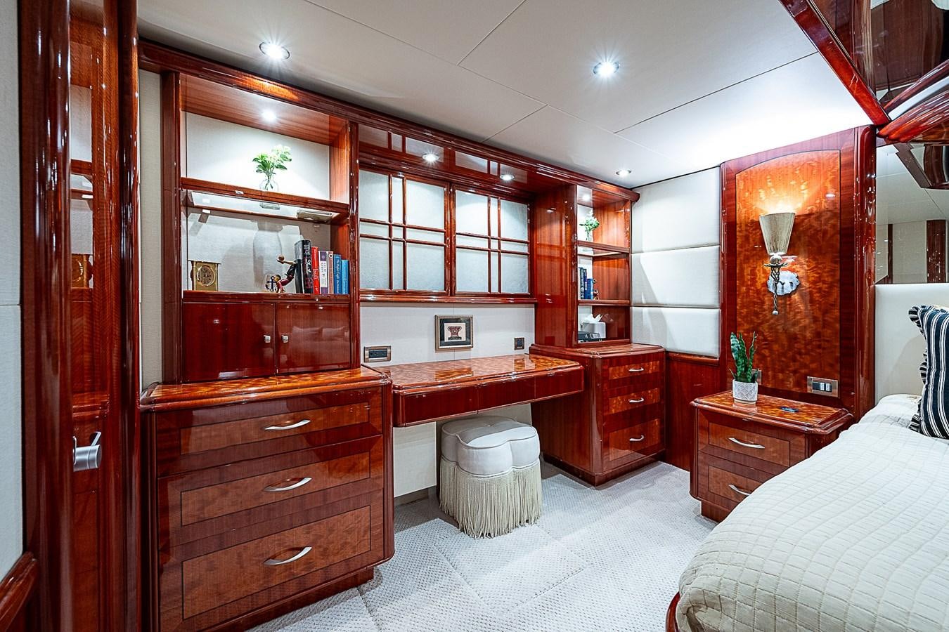 a bedroom with a bed and desk aboard FINALLY Yacht for Sale