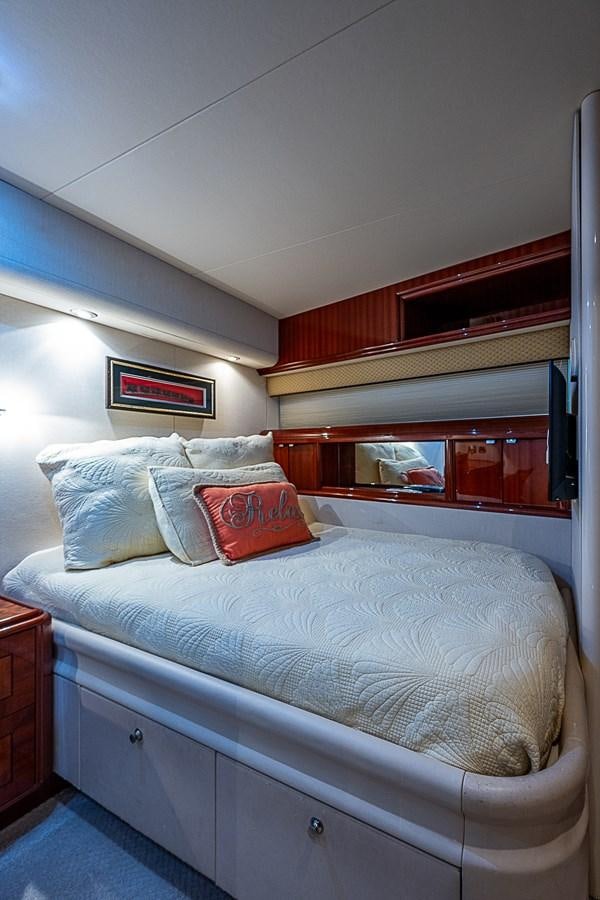 a bed with white sheets and pillows aboard FINALLY Yacht for Sale