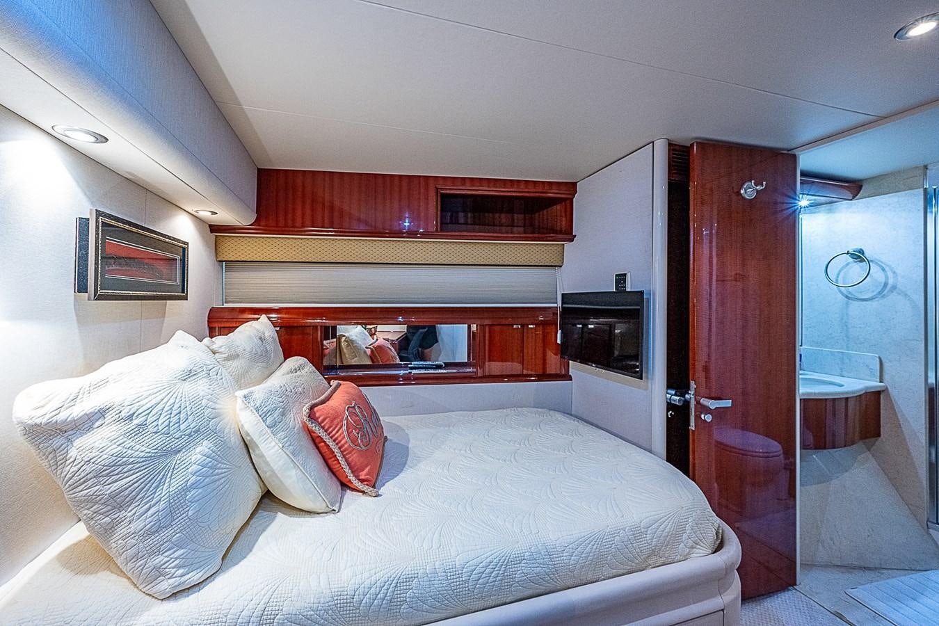a bedroom with a bed and a wood door aboard FINALLY Yacht for Sale