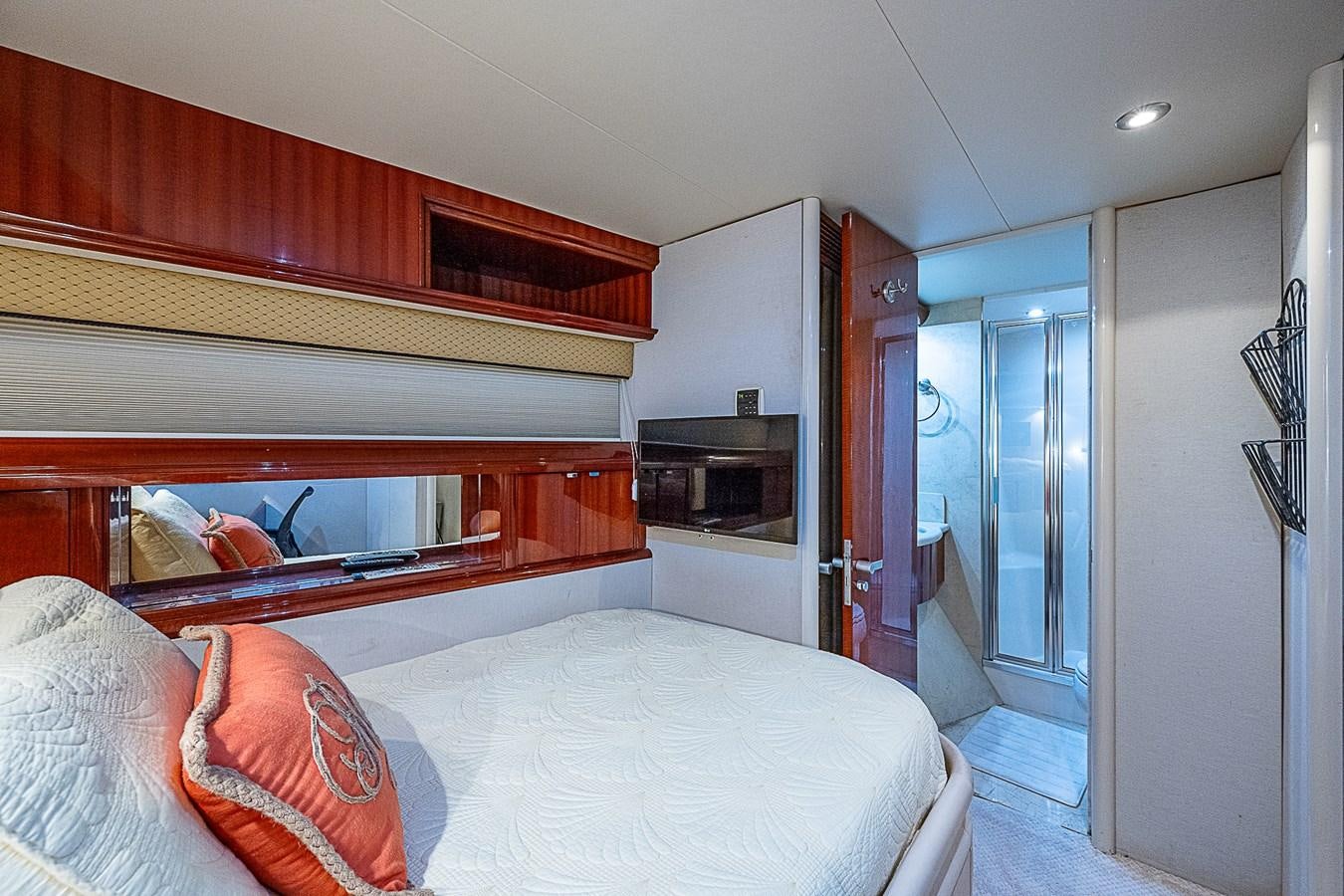 a bedroom with a bed and a television aboard FINALLY Yacht for Sale