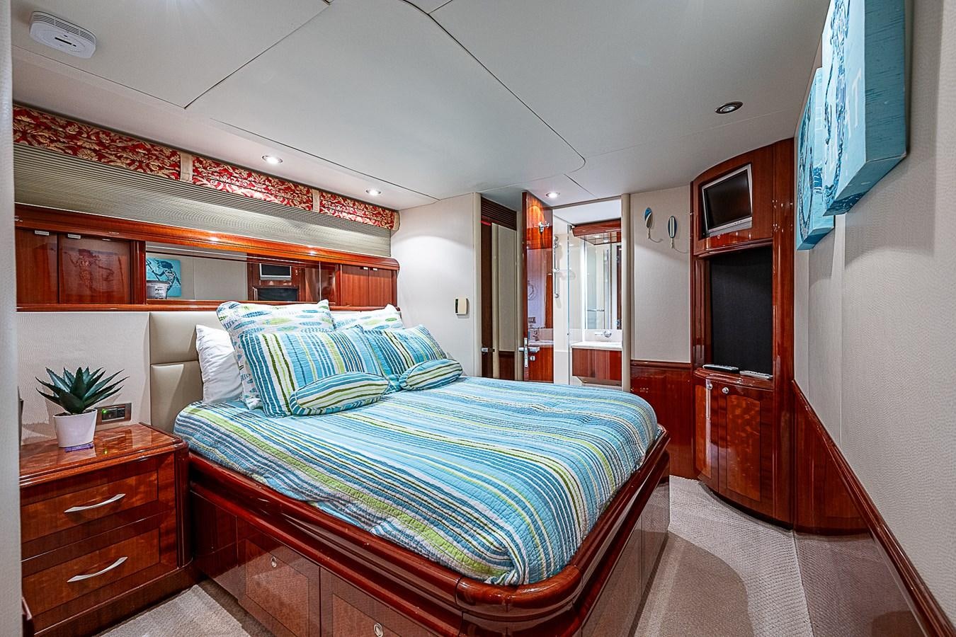 a bedroom with a bed and a desk aboard FINALLY Yacht for Sale