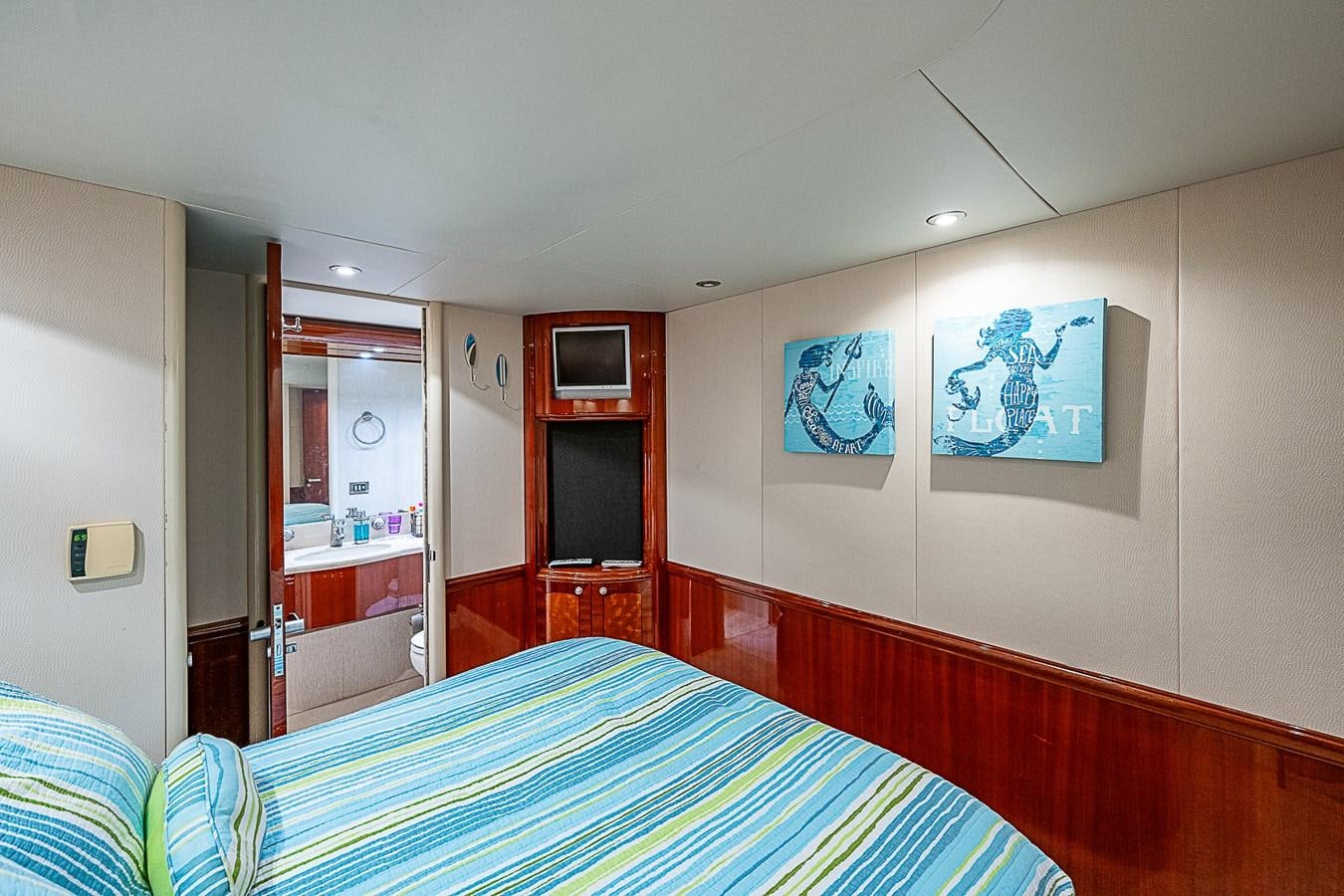 a bedroom with a bed and a mirror aboard FINALLY Yacht for Sale