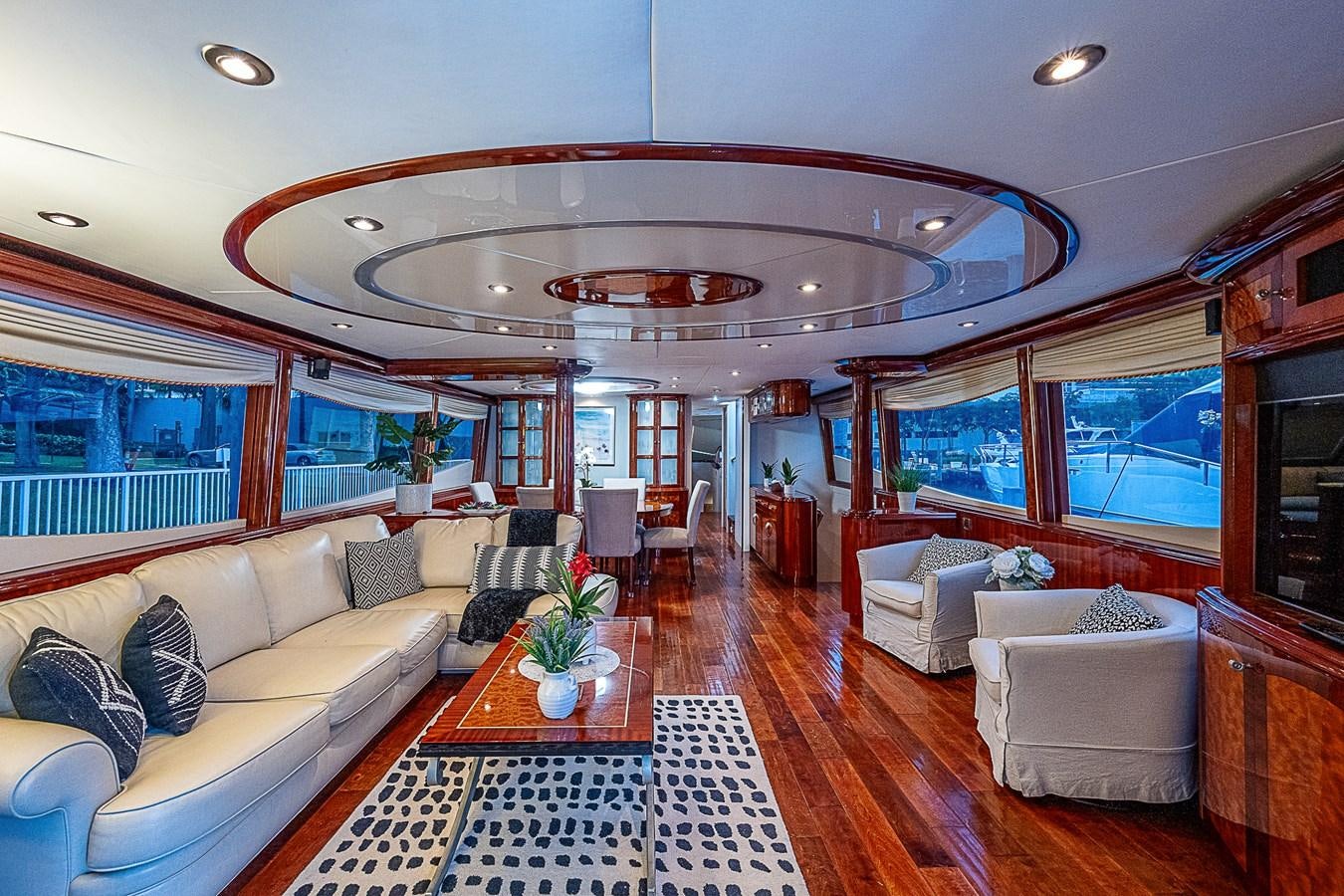 a living room with a large chandelier aboard FINALLY Yacht for Sale
