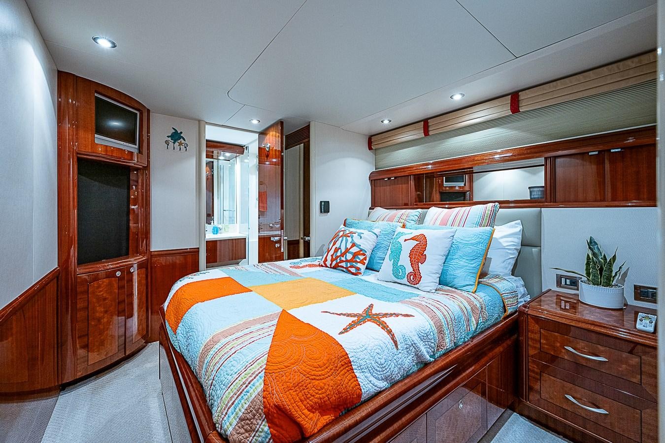 a bedroom with a bed and a dresser aboard FINALLY Yacht for Sale