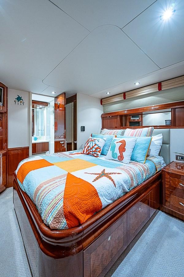 a bed with a blue and orange blanket aboard FINALLY Yacht for Sale