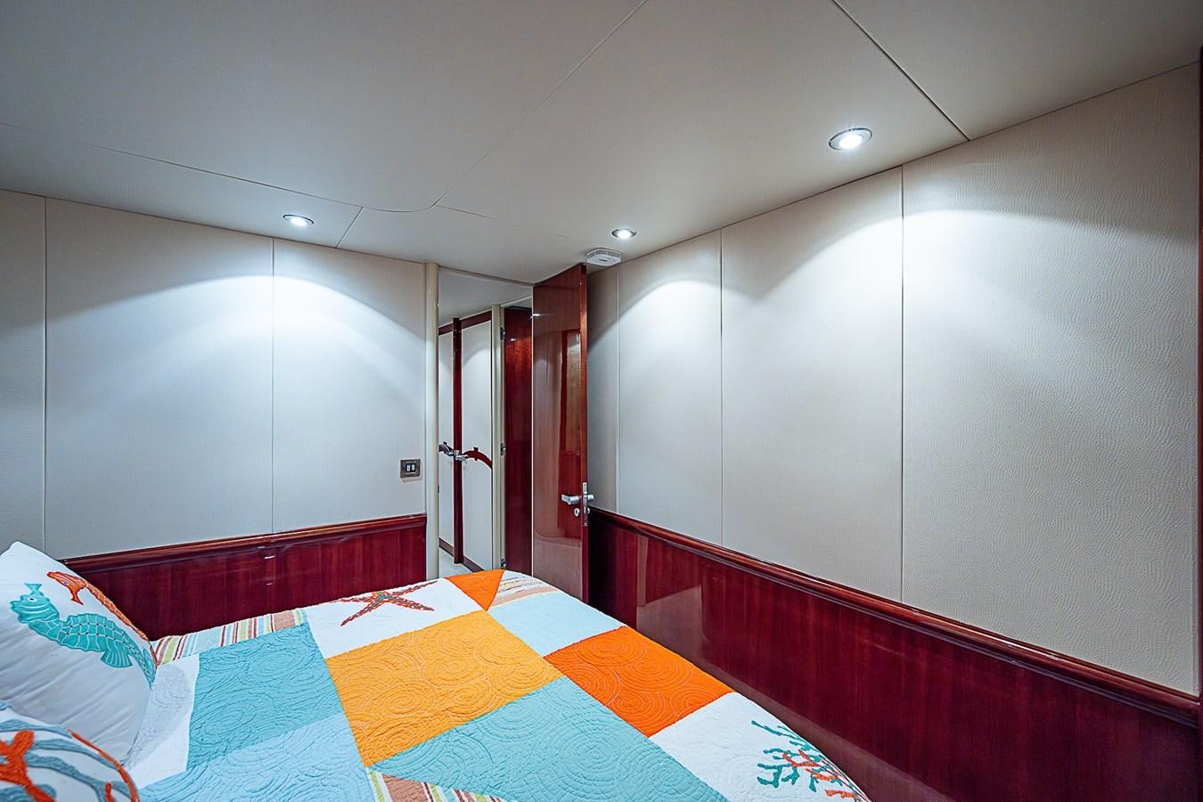 a bedroom with a bed and a door aboard FINALLY Yacht for Sale