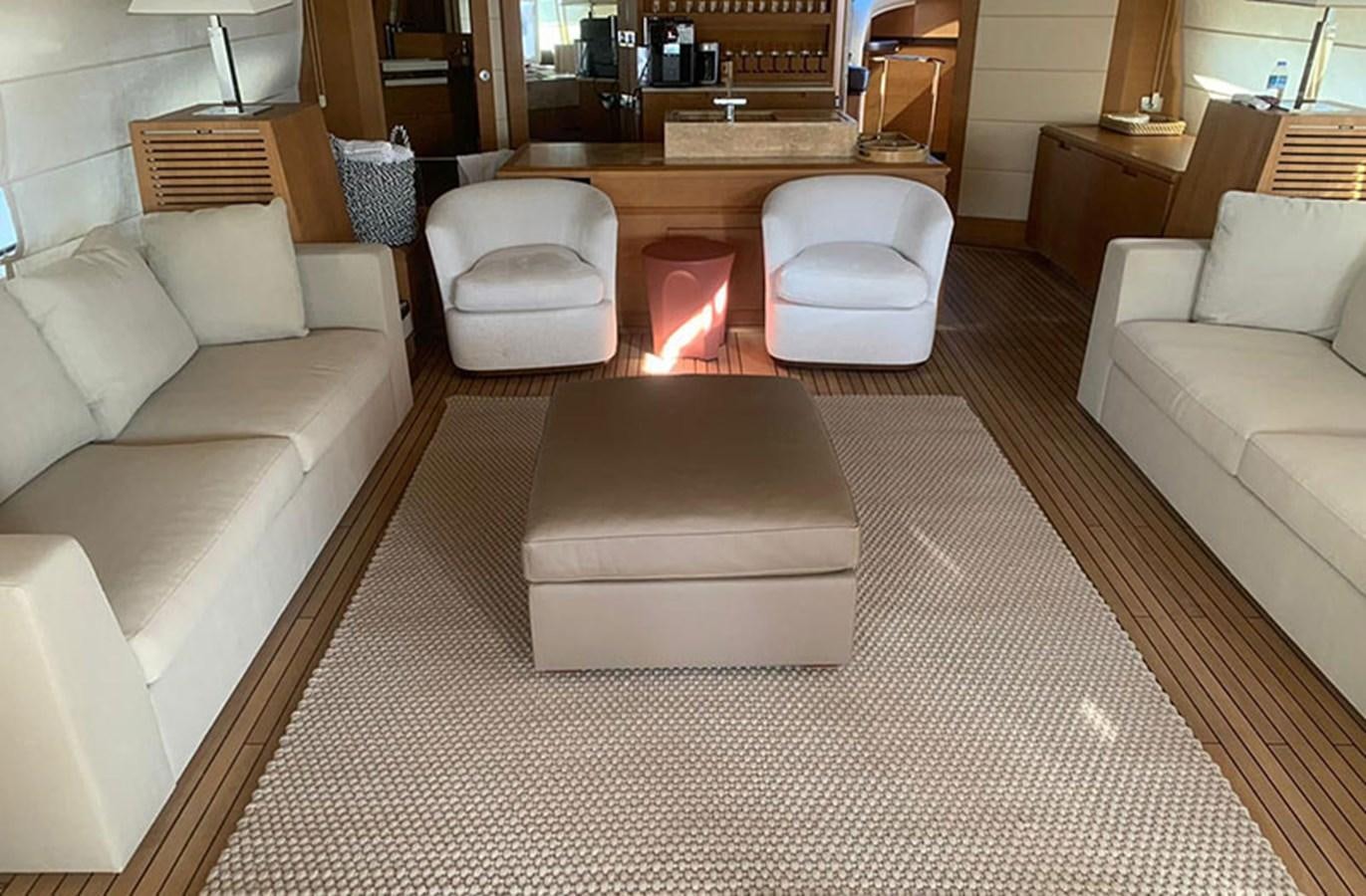 a living room with a couch and a coffee table aboard 100 LEONARDO Yacht for Sale