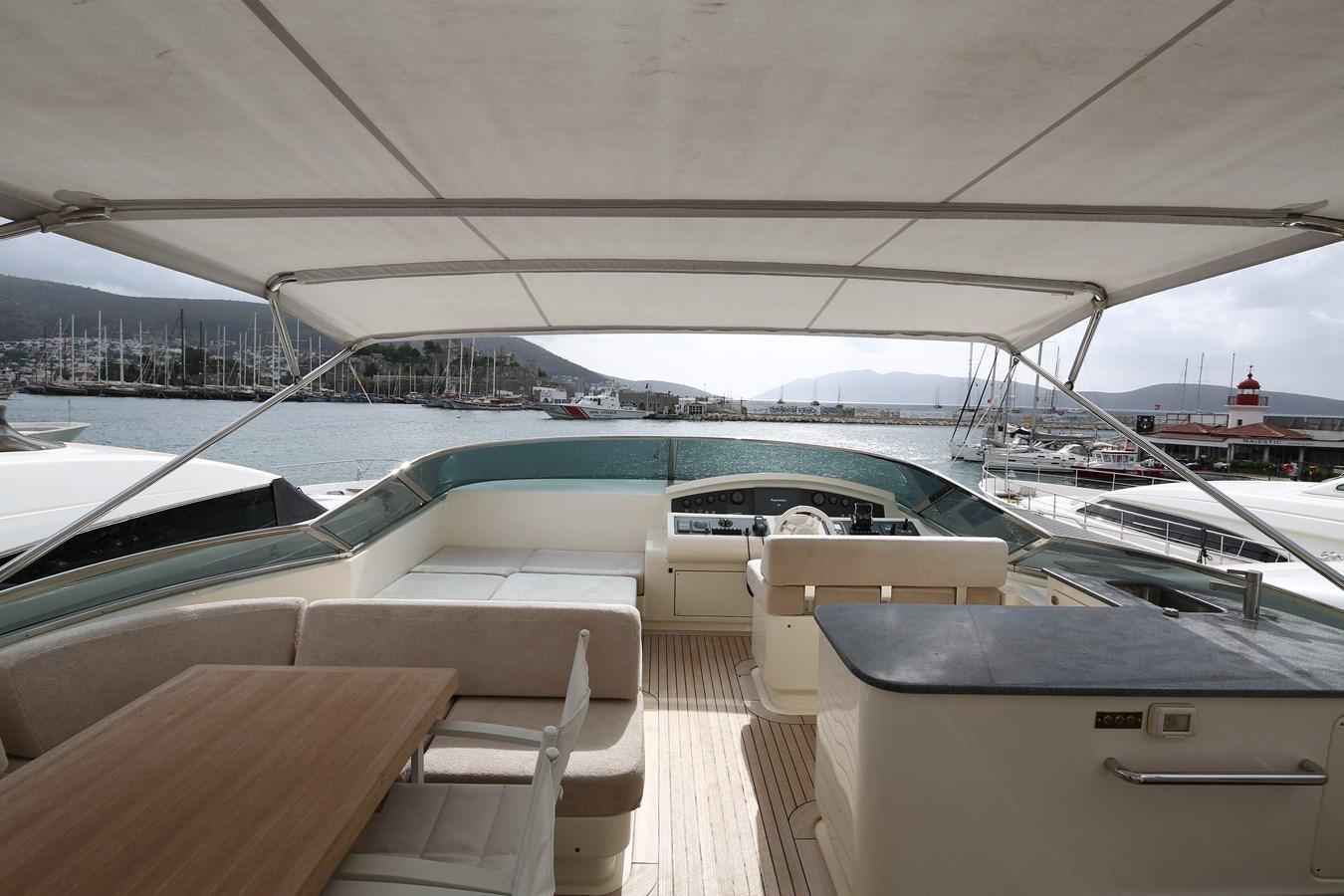 a deck with a view of a marina and boats aboard 100 LEONARDO Yacht for Sale