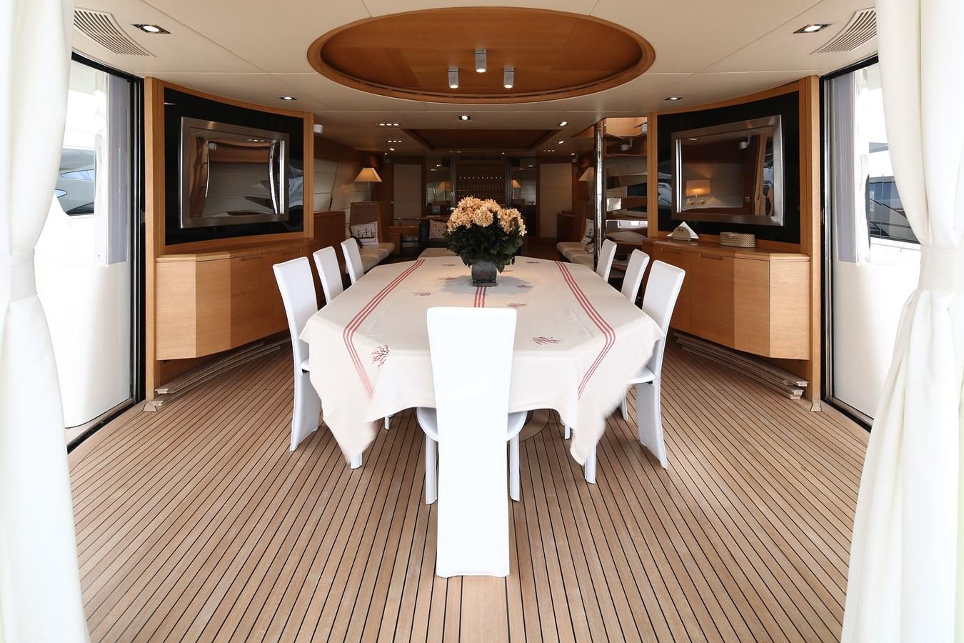 a room with a table and chairs aboard 100 LEONARDO Yacht for Sale