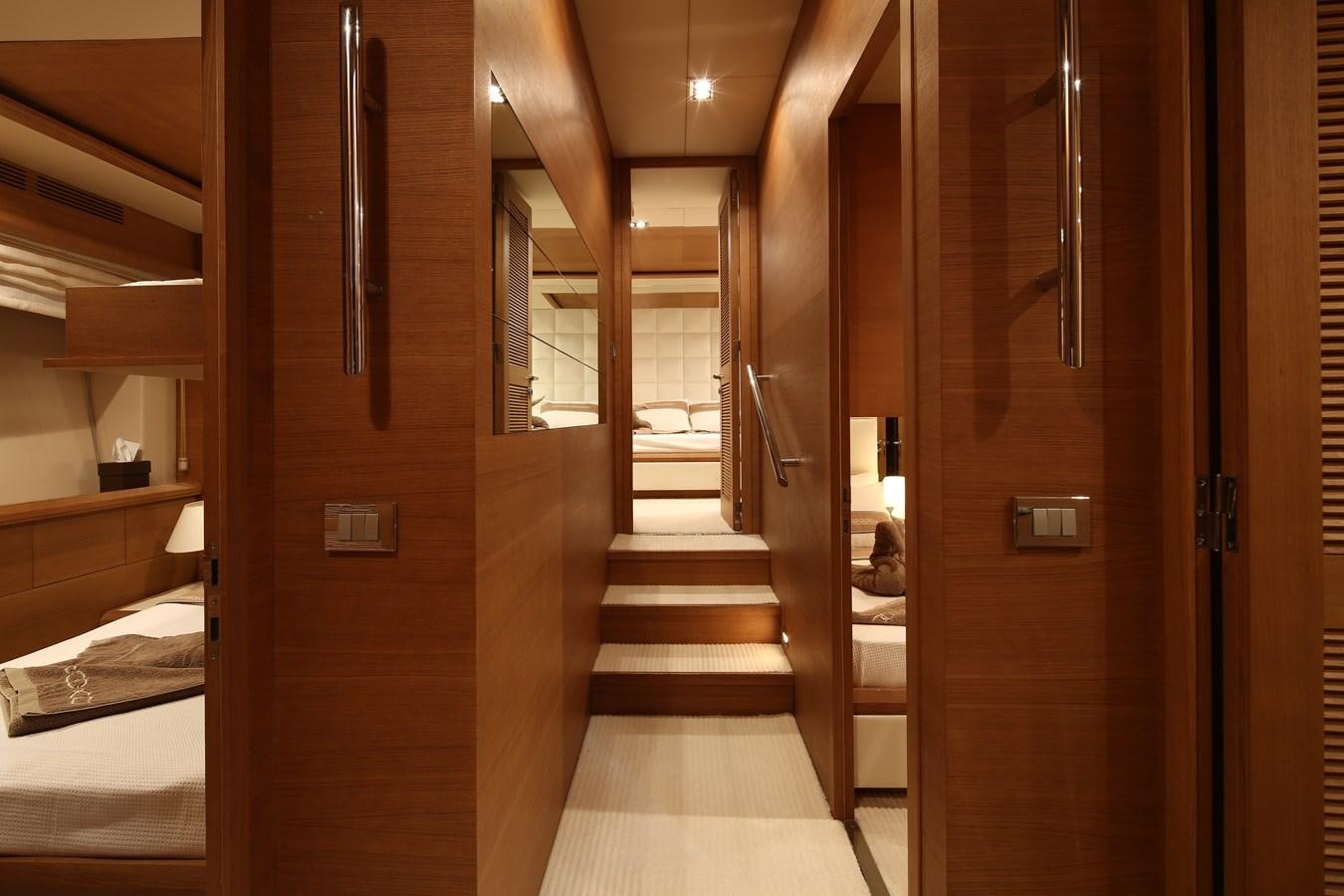 a room with a wood door and a bed aboard 100 LEONARDO Yacht for Sale