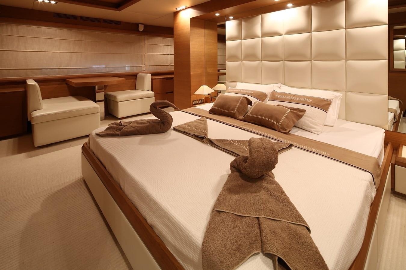 a room with a bed and a couch aboard 100 LEONARDO Yacht for Sale
