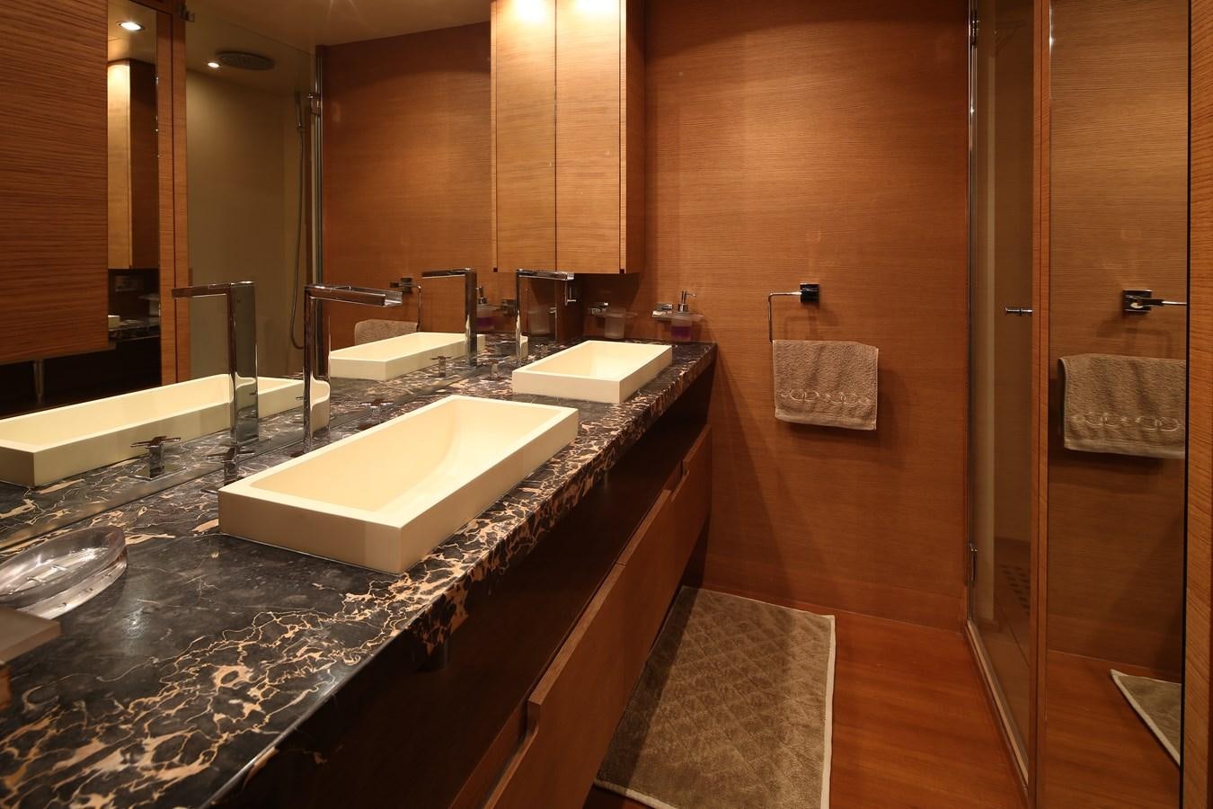 a bathroom with a countertop sink and mirror aboard 100 LEONARDO Yacht for Sale