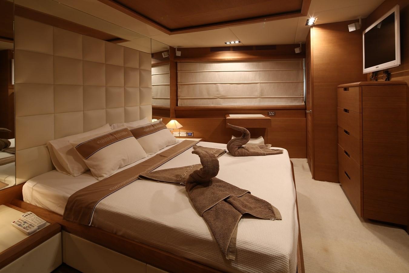 a person lying on a bed aboard 100 LEONARDO Yacht for Sale