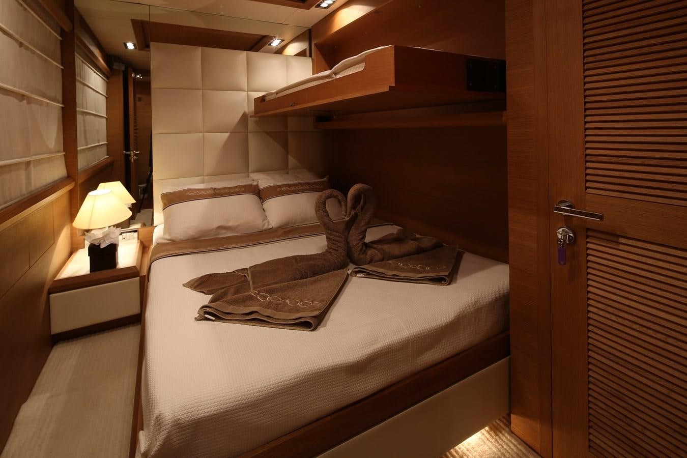 a bed with a white sheet aboard 100 LEONARDO Yacht for Sale