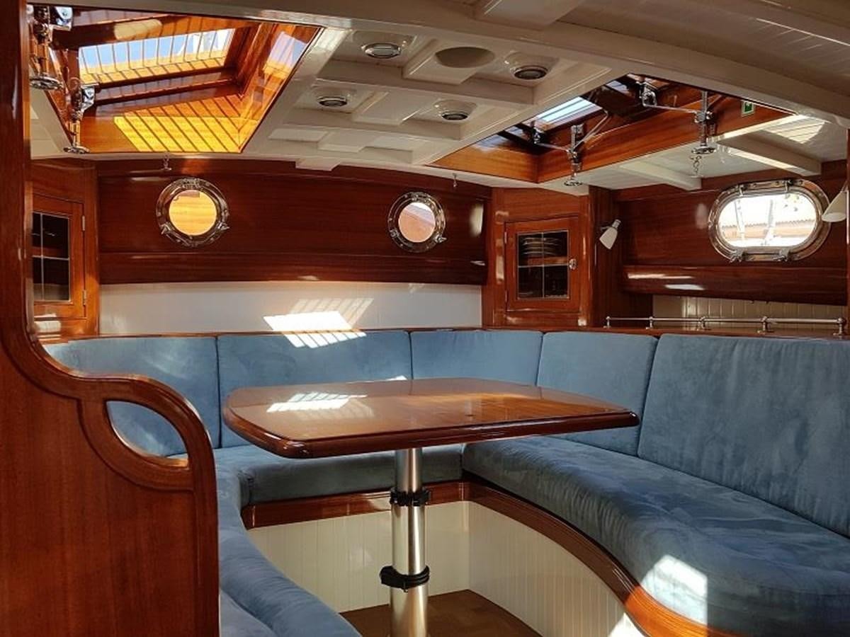 a room with a table and chairs aboard TIOGA OF HAMBURG Yacht for Sale