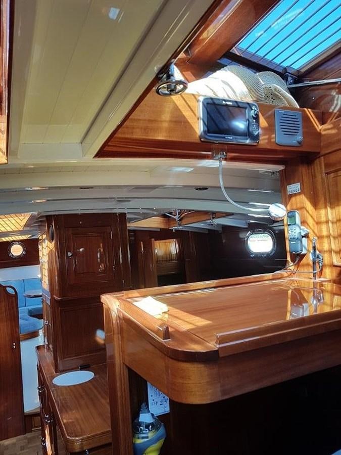a wooden desk with a television on it aboard TIOGA OF HAMBURG Yacht for Sale