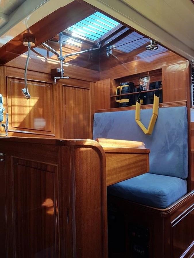 a room with a wood paneled wall and a chair aboard TIOGA OF HAMBURG Yacht for Sale