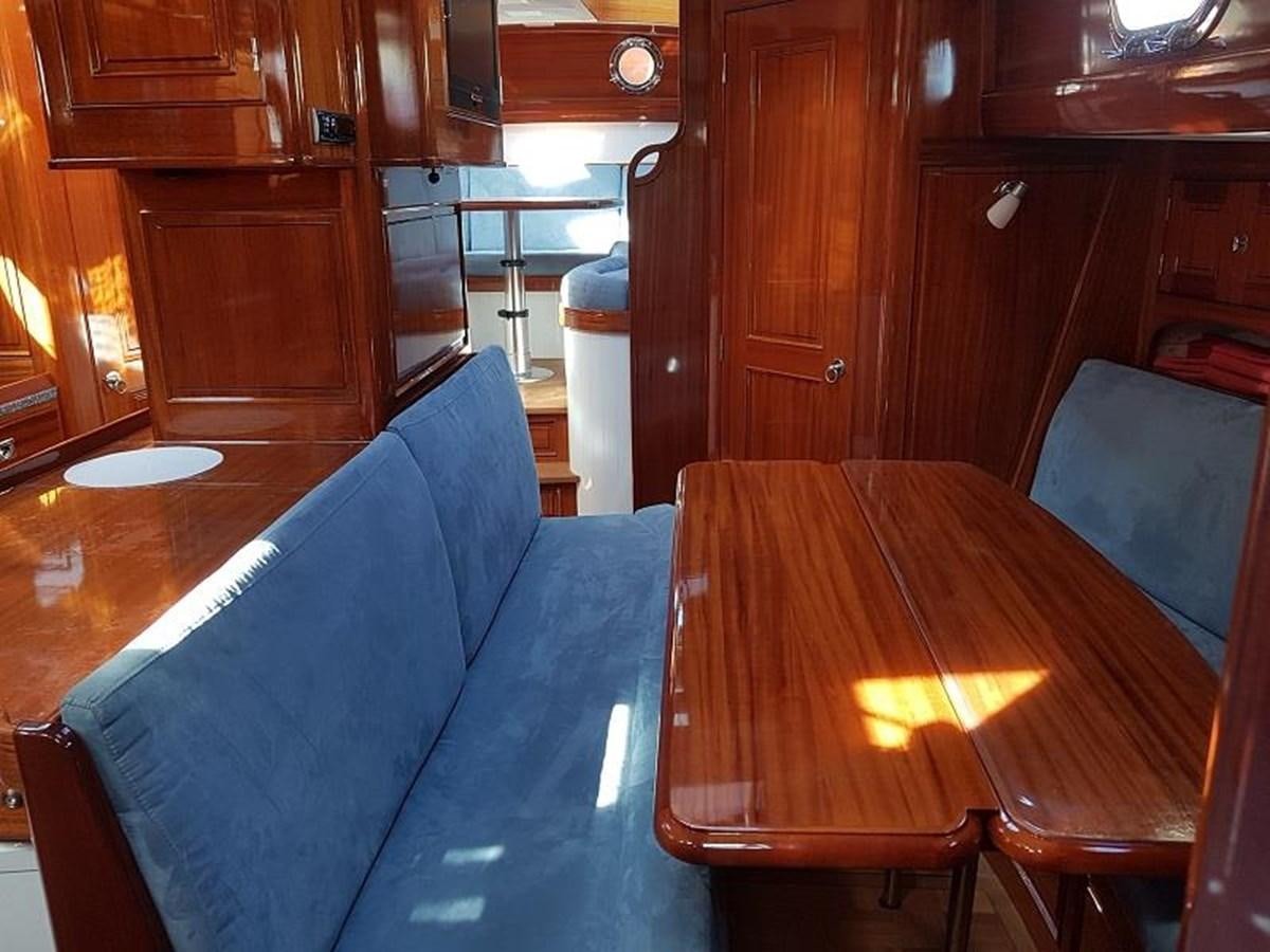 a table with chairs around it aboard TIOGA OF HAMBURG Yacht for Sale