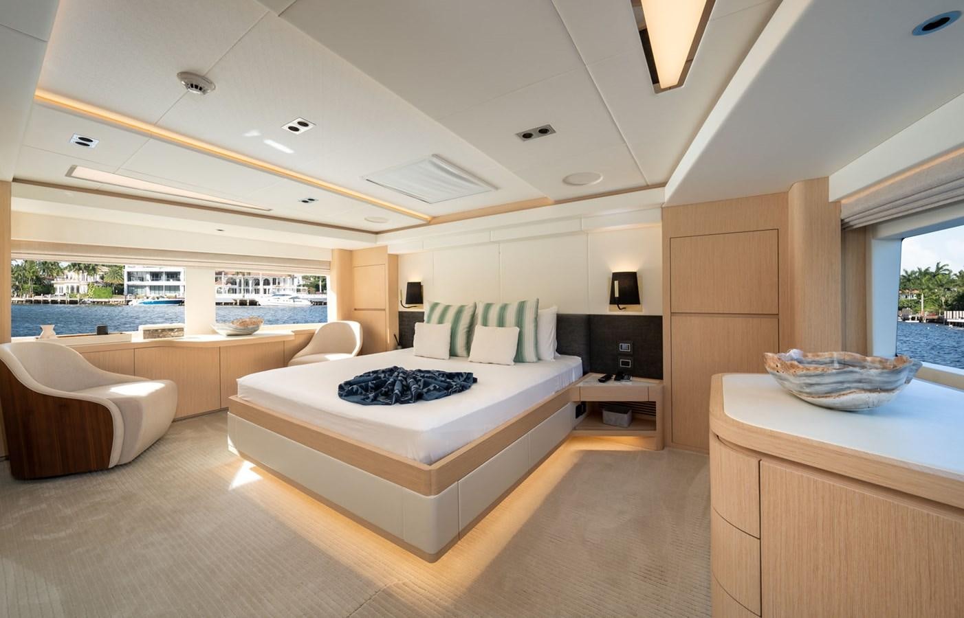 a large modern bedroom with a large balcony aboard SANTOSH Yacht for Sale
