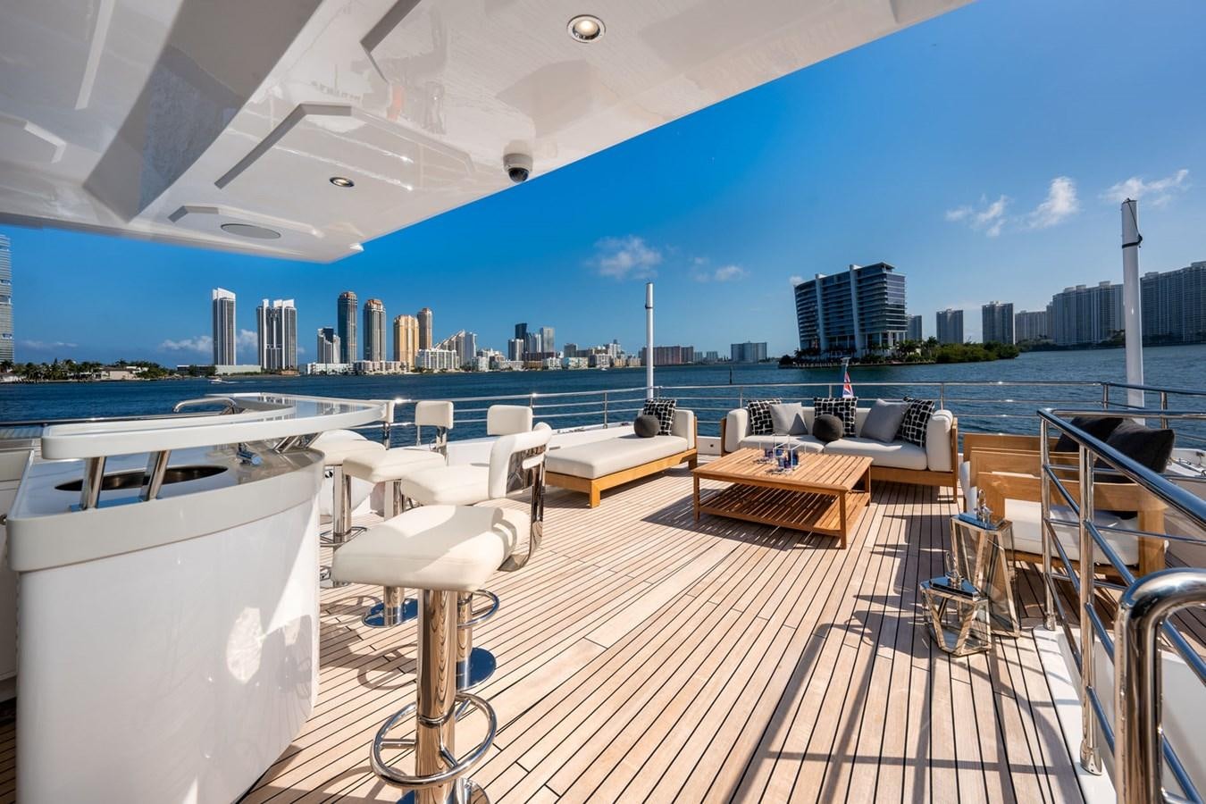 a deck with a view of a city and water aboard SANTOSH Yacht for Sale