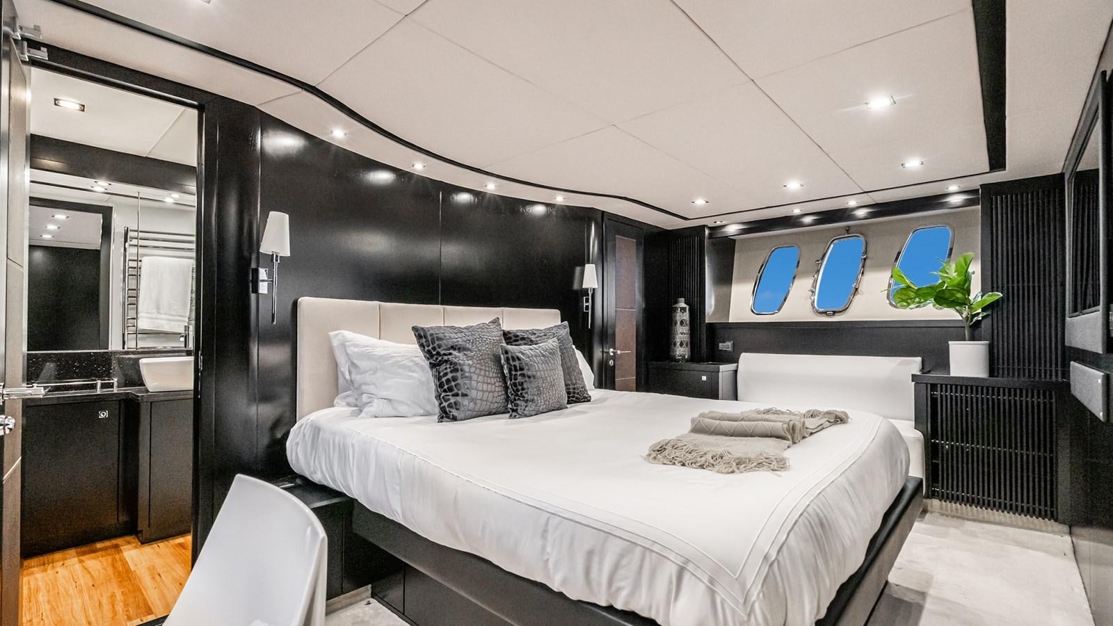 a room with a bed and a desk aboard NORMA JEAN Yacht for Sale