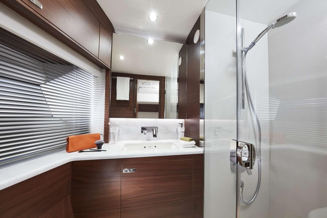 a bathroom with a shower unit and sink aboard SHINE Yacht for Sale